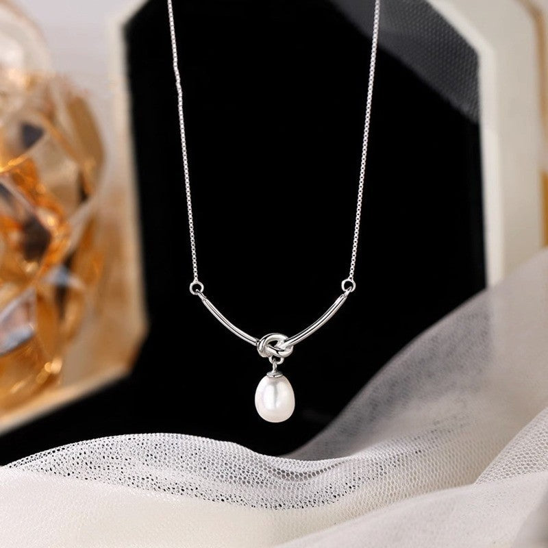 Damen Halskette mit elegantem Perlenanhänger und modernem Bogen-Design Shop Nory