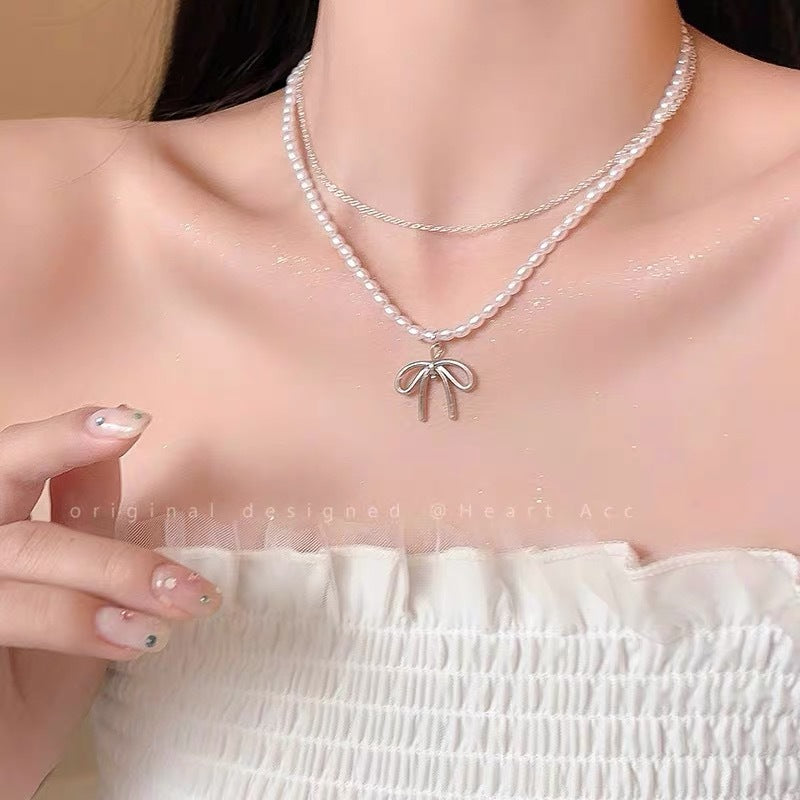 Damen Halskette mit luxuriösen Perlen und filigranem Schleifenanhänger Shop Nory