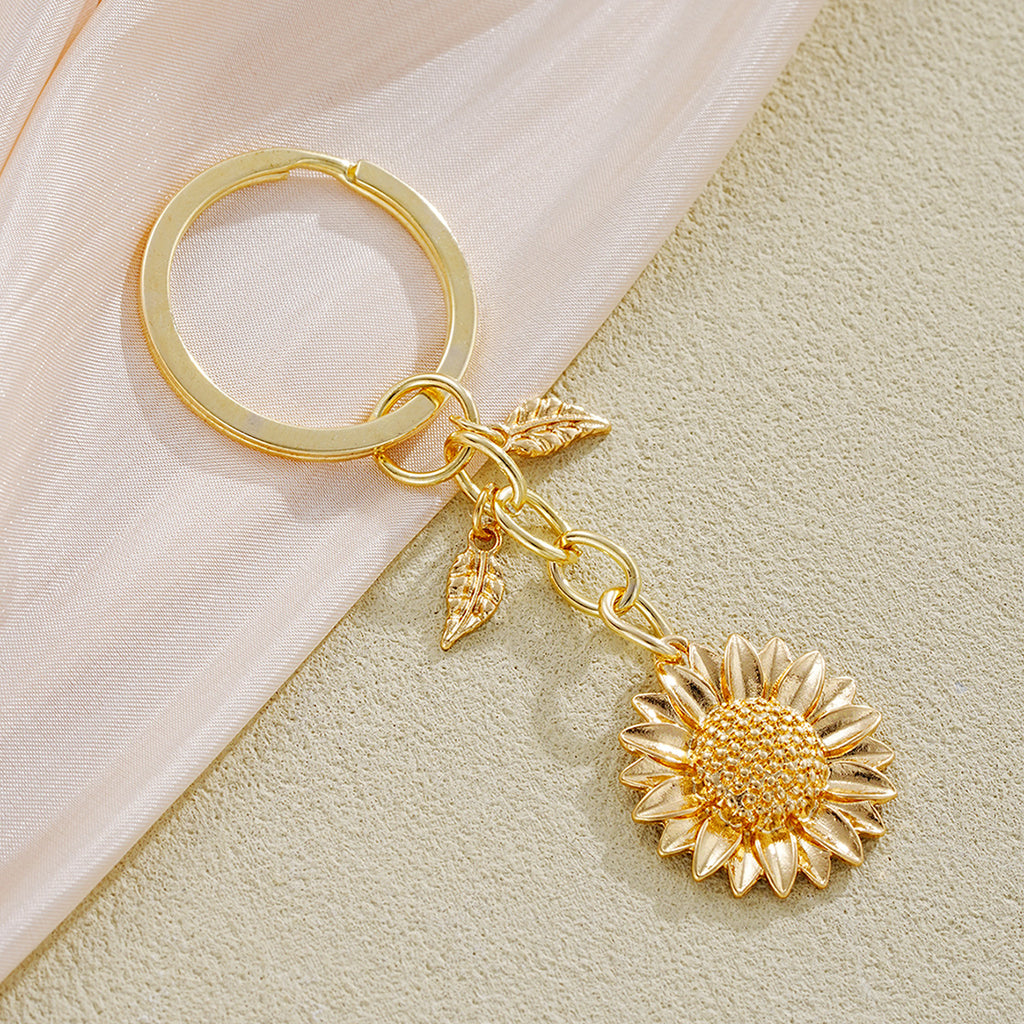 Damen Schlüsselanhänger mit filigranem Sonnenblumen-Design und elegantem Blattakzent Shop Nory