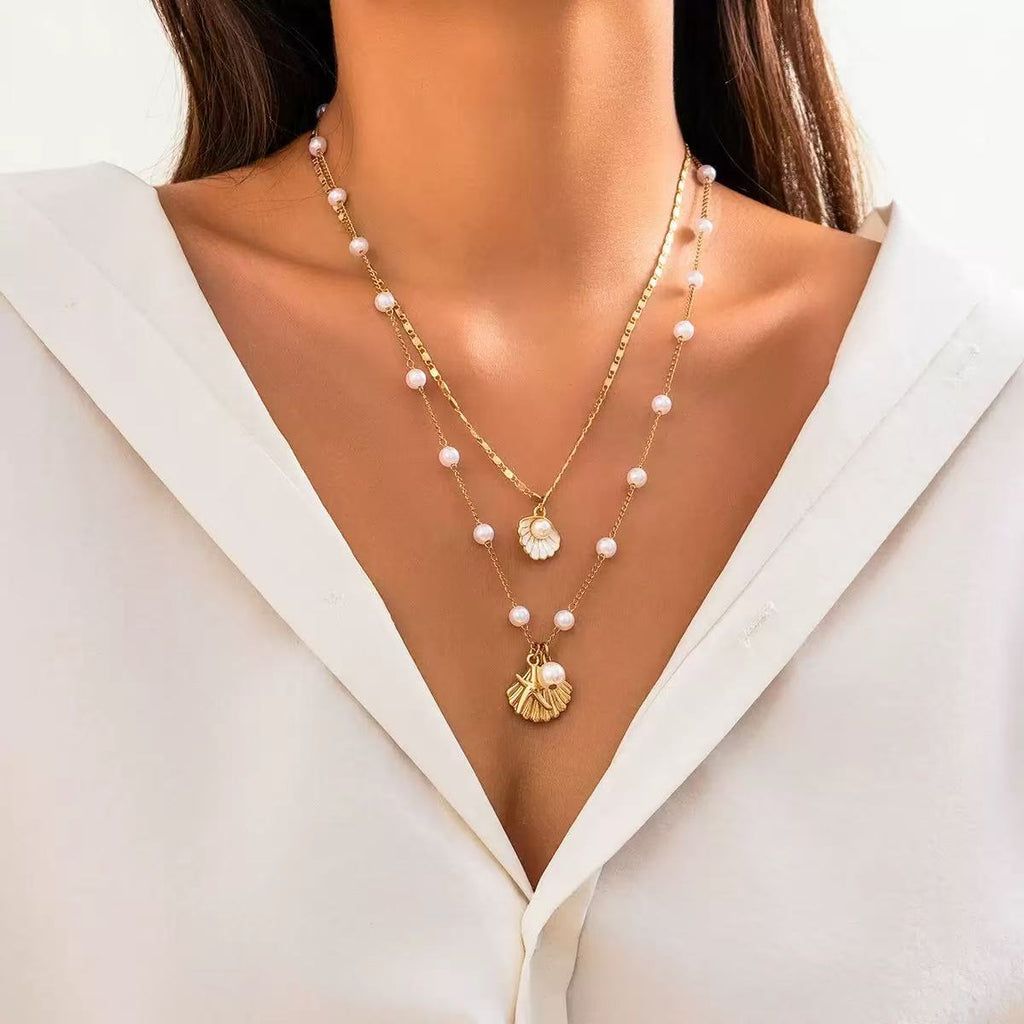 Damen mehrlagige Halskette mit Muschelanhängern und eleganten Perlen-Details Shop Nory