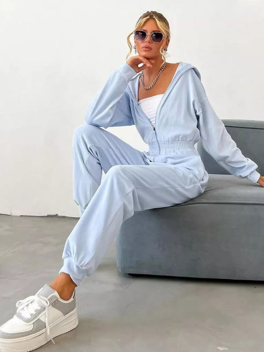 Damen Velours Jumpsuit mit Kapuze, Reißverschluss und tailliertem Gummibund Shop Nory