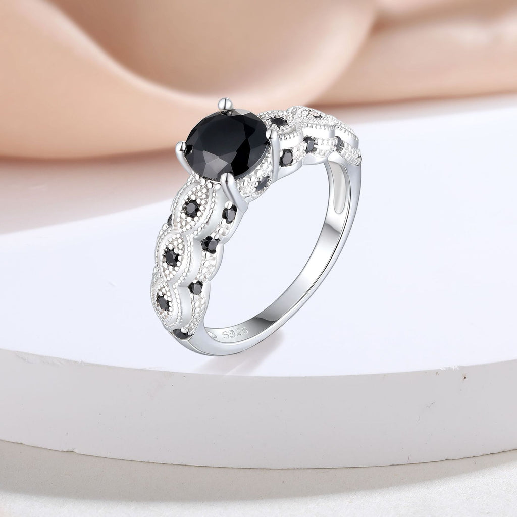 Damen eleganter Ring mit schwarz gefasstem Hauptstein und floralen Verzierungen Shop Nory