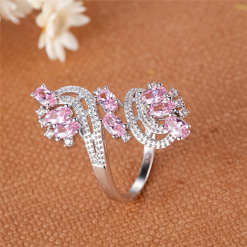 Damenring mit kunstvollem Wellenmuster und eleganten rosa Kristallen Shop Nory