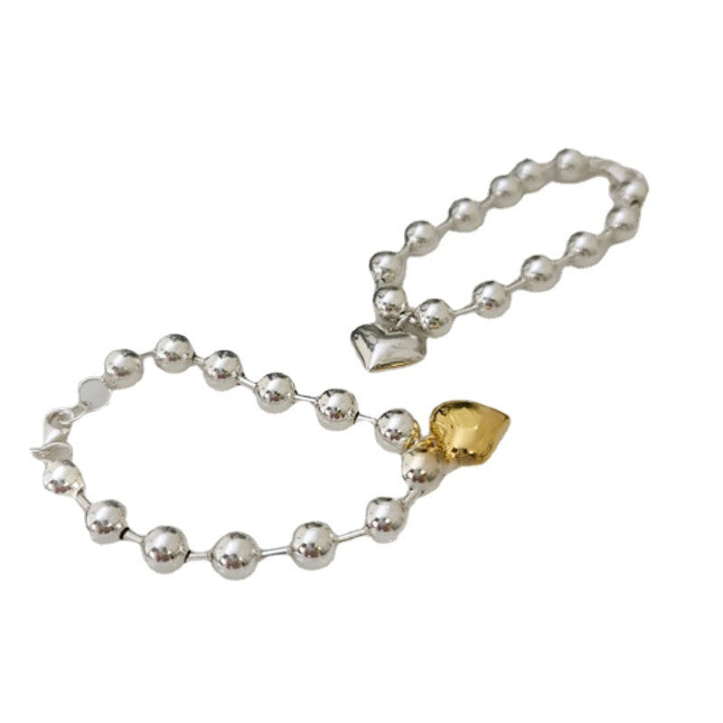Damenarmband mit herzförmigem Anhänger und eleganten Perlen Shop Nory