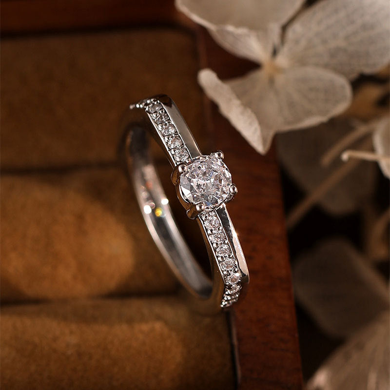 Damen Eleganter Verlobungsring mit funkelndem zentralen Stein und dezenten Zirkonia Shop Nory