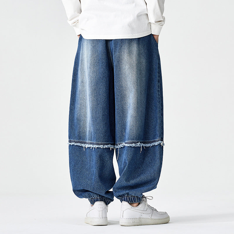 Herren Weit geschnittene Baggy-Denim-Hose mit Tunnelzug, elastischen Beinabschlüssen und Fransen-Detail Shop Nory