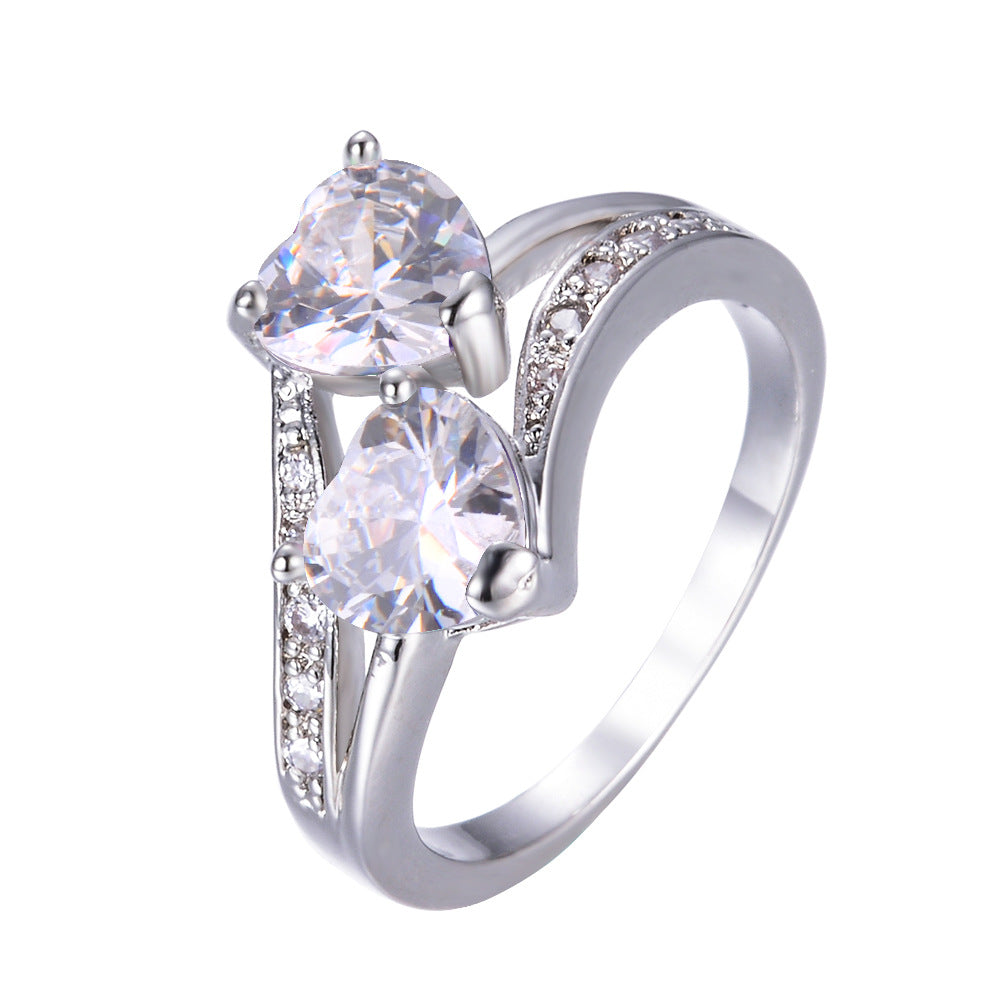 Damen Ring mit zwei herzförmigen blauen Zirkonen und funkelnden Zirkonia-Details Shop Nory