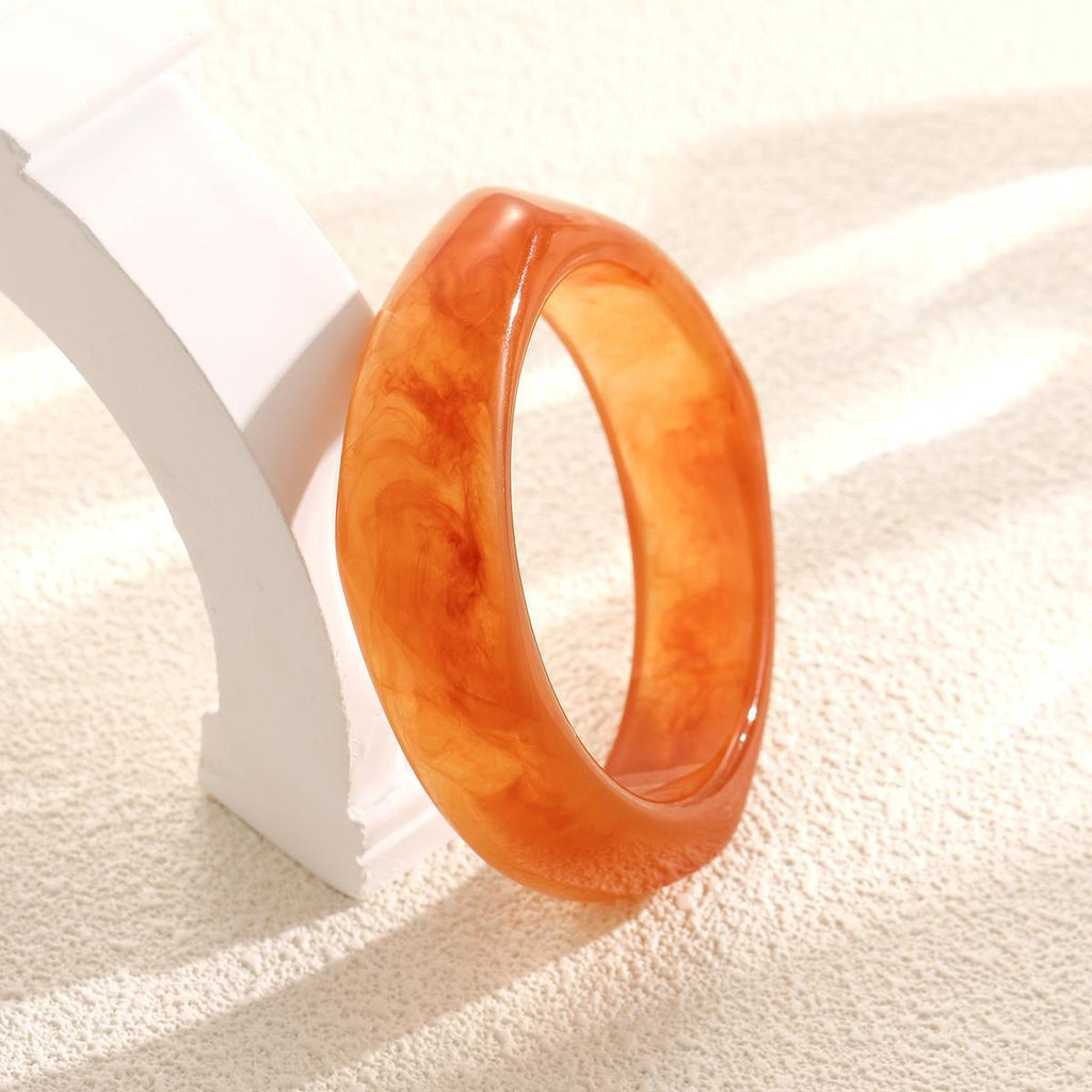 Damenarmreif aus hochwertigem Acryl mit eleganter, geschwungener Form Shop Nory