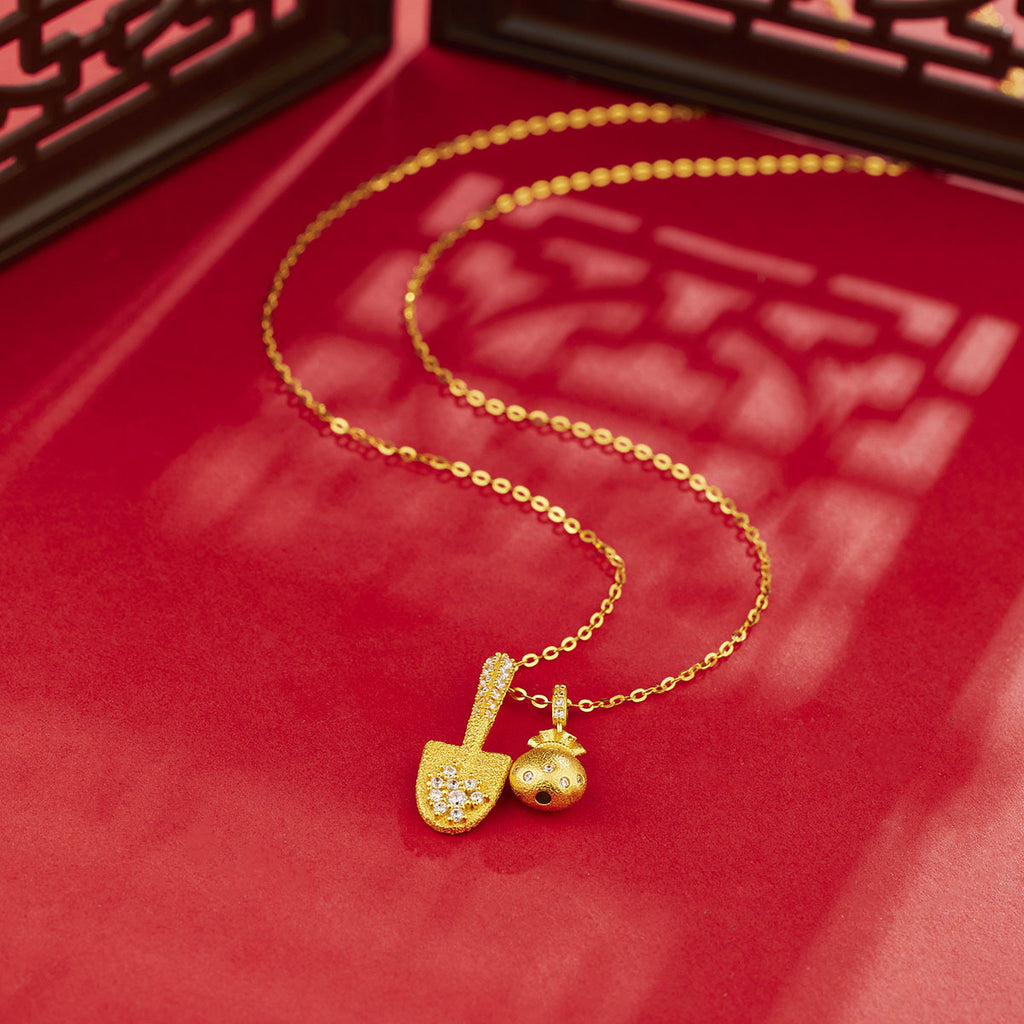 Damen Halskette mit goldfarbenem Schaufel- und Geldbeutel-Anhänger und funkelnden Kristallen Shop Nory