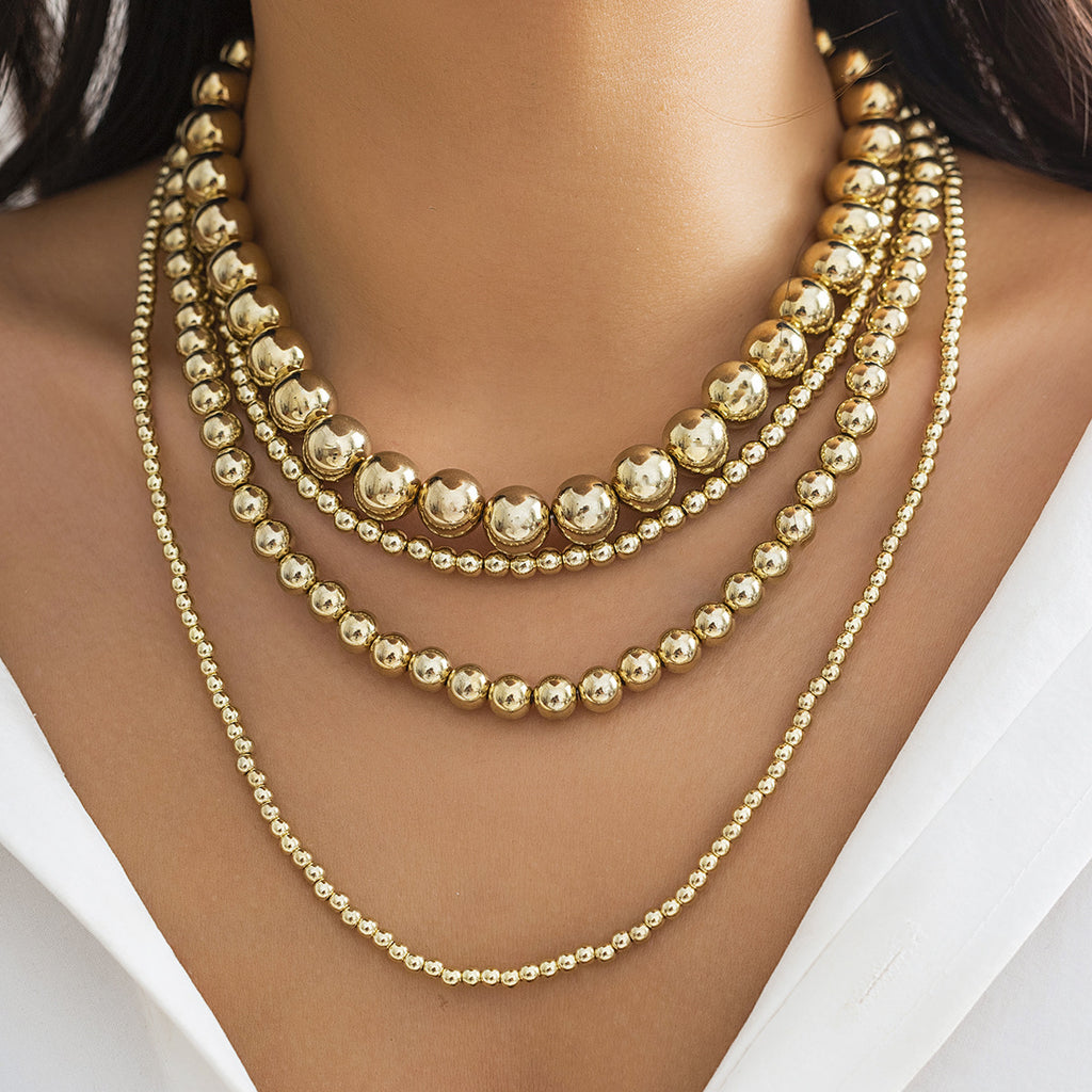 Damen mehrlagige Halskette mit glänzenden Metallkugeln und eleganten Designelementen