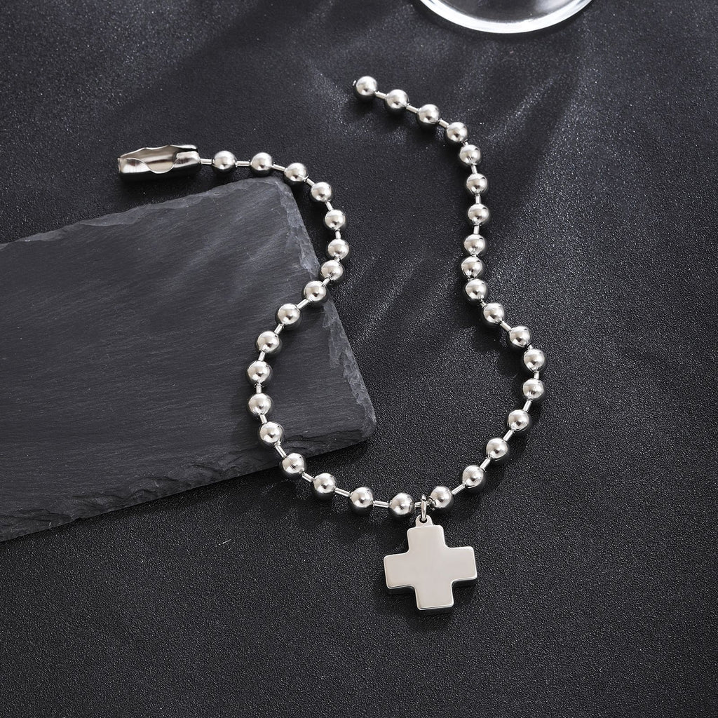 Damenarmband mit Kreuzanhänger und glänzenden Perlen Shop Nory