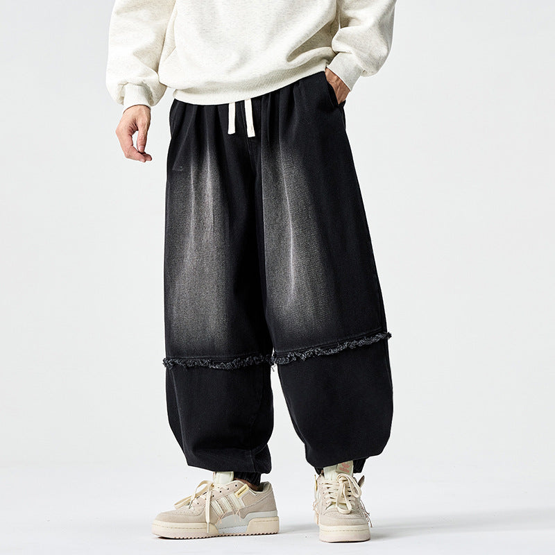 Herren Weit geschnittene Baggy-Denim-Hose mit Tunnelzug, elastischen Beinabschlüssen und Fransen-Detail Shop Nory