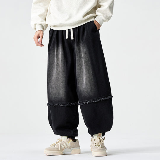Herren Weit geschnittene Baggy-Denim-Hose mit Tunnelzug, elastischen Beinabschlüssen und Fransen-Detail Shop Nory