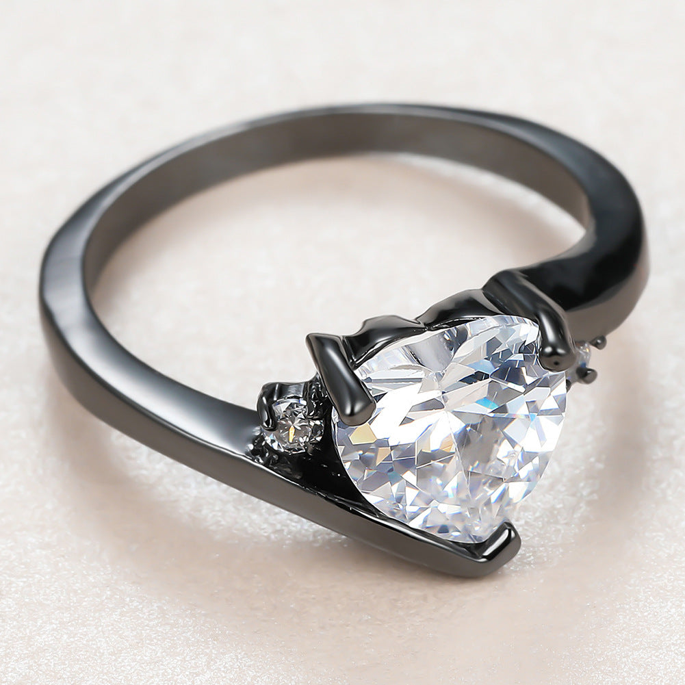 Damen Ring mit herzförmigem blauen Zirkonstein und eleganter schwarzer Fassung Shop Nory