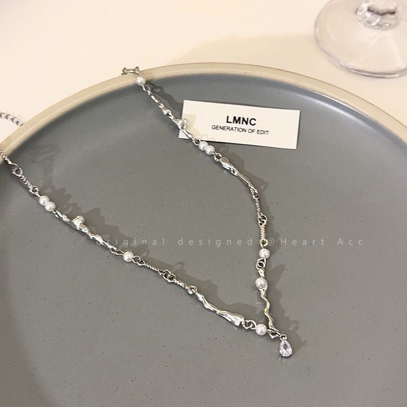 Damen Armband mit eleganten Perlen und geschwungenen Elementen Shop Nory
