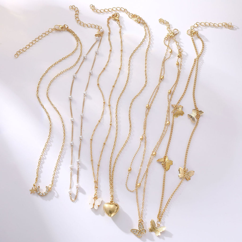 Damen Halskette Set aus feinen goldenen Ketten mit verspielten Anhängern Shop Nory