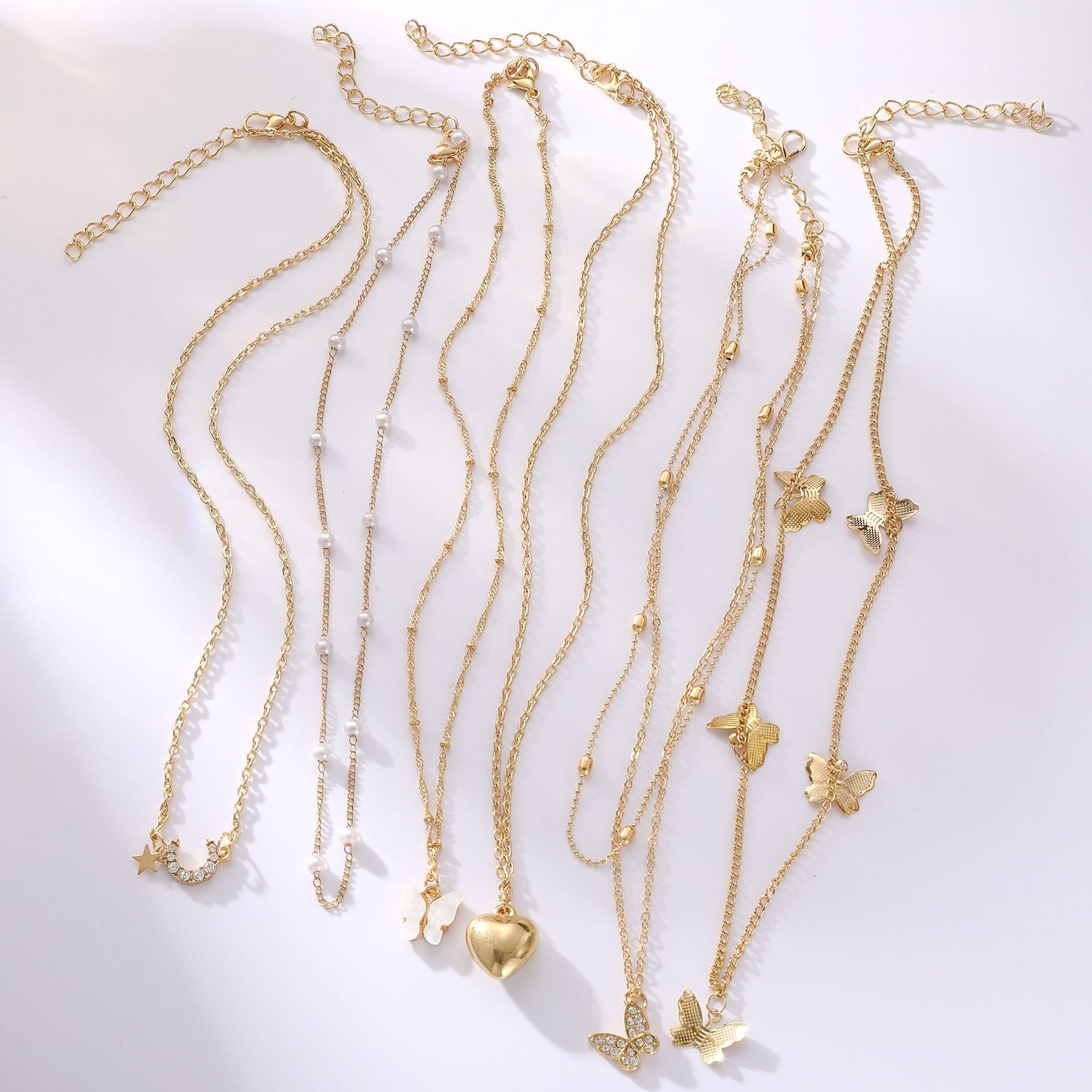 Damen Halskette Set aus feinen goldenen Ketten mit verspielten Anhängern Shop Nory
