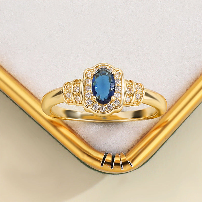 Damenring mit ovalem blauem Edelstein und funkelnden Zirkonia-Steinen Shop Nory