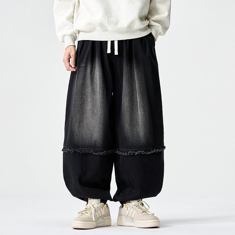 Herren Weit geschnittene Baggy-Denim-Hose mit Tunnelzug, elastischen Beinabschlüssen und Fransen-Detail Shop Nory