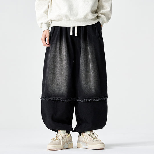 Herren Weit geschnittene Baggy-Denim-Hose mit Tunnelzug, elastischen Beinabschlüssen und Fransen-Detail Shop Nory
