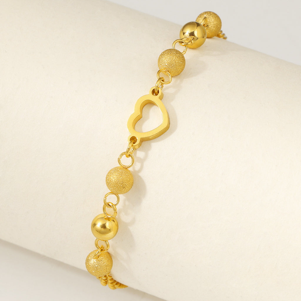 Damen modisches Armband mit funkelnden Kugeldetails und Herzanhänger Shop Nory