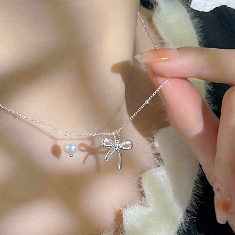 Damen Kettenanhänger mit Schleifenmotiv und Perle Shop Nory