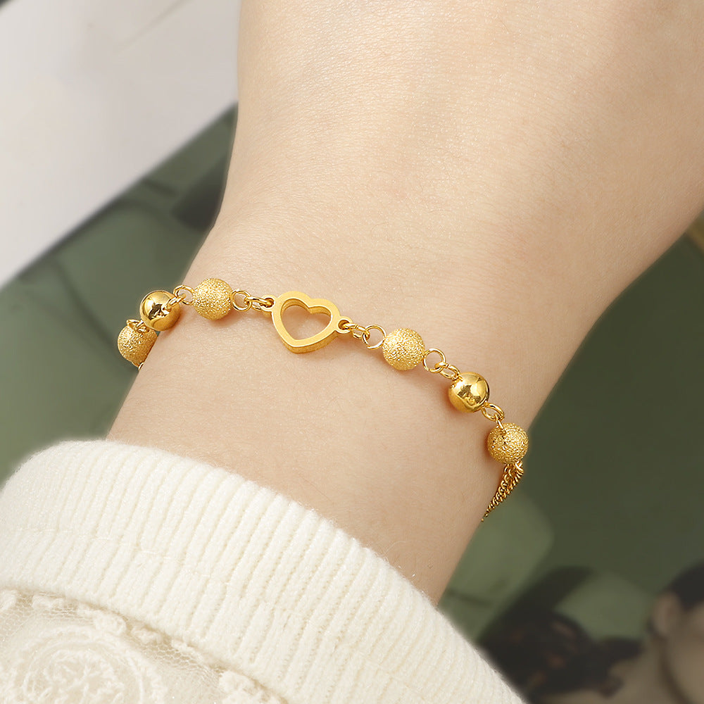 Damen modisches Armband mit funkelnden Kugeldetails und Herzanhänger Shop Nory