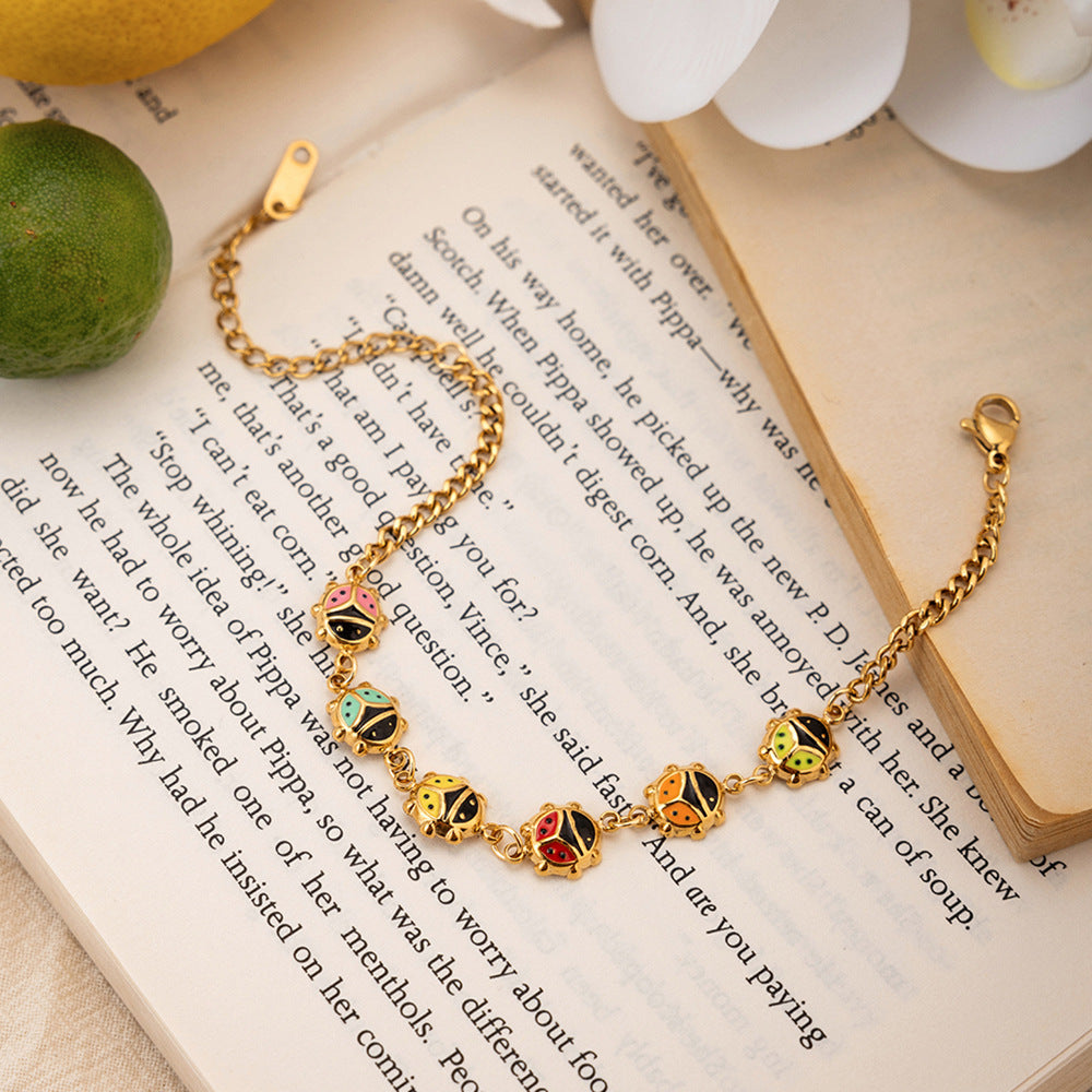 Damen Armband mit bunten Marienkäfer-Anhängern aus Edelstahl Shop Nory