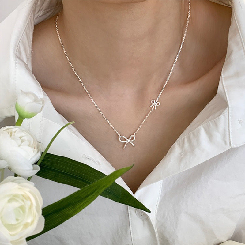 Damen Silberne Halskette mit stilvollem Schleifen-Design Shop Nory