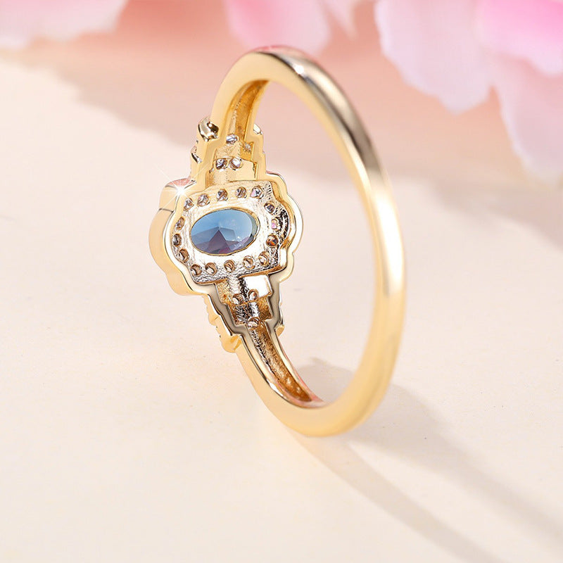 Damenring mit ovalem blauem Edelstein und funkelnden Zirkonia-Steinen Shop Nory