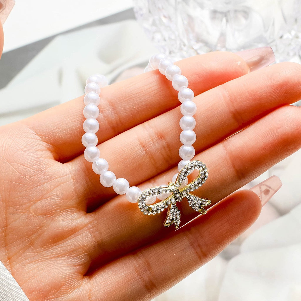 Damen Perlenhalskette mit glamourösem Schleifenanhänger Shop Nory