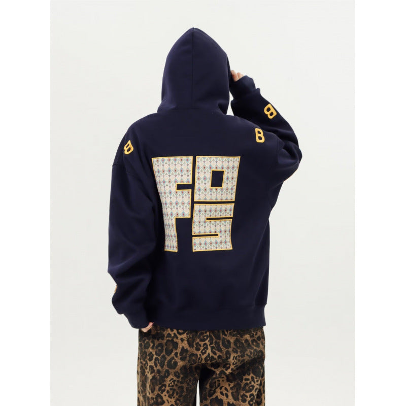Unisex Oversized Kapuzenpullover mit großflächigem Intarsien‑Blockprint und geripptem Saum Shop Nory