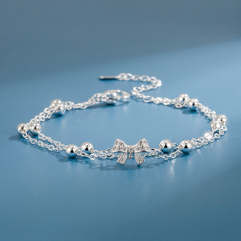 Damen Armband mit zartem Schleifen-Design und funkelnden Kristallen Shop Nory