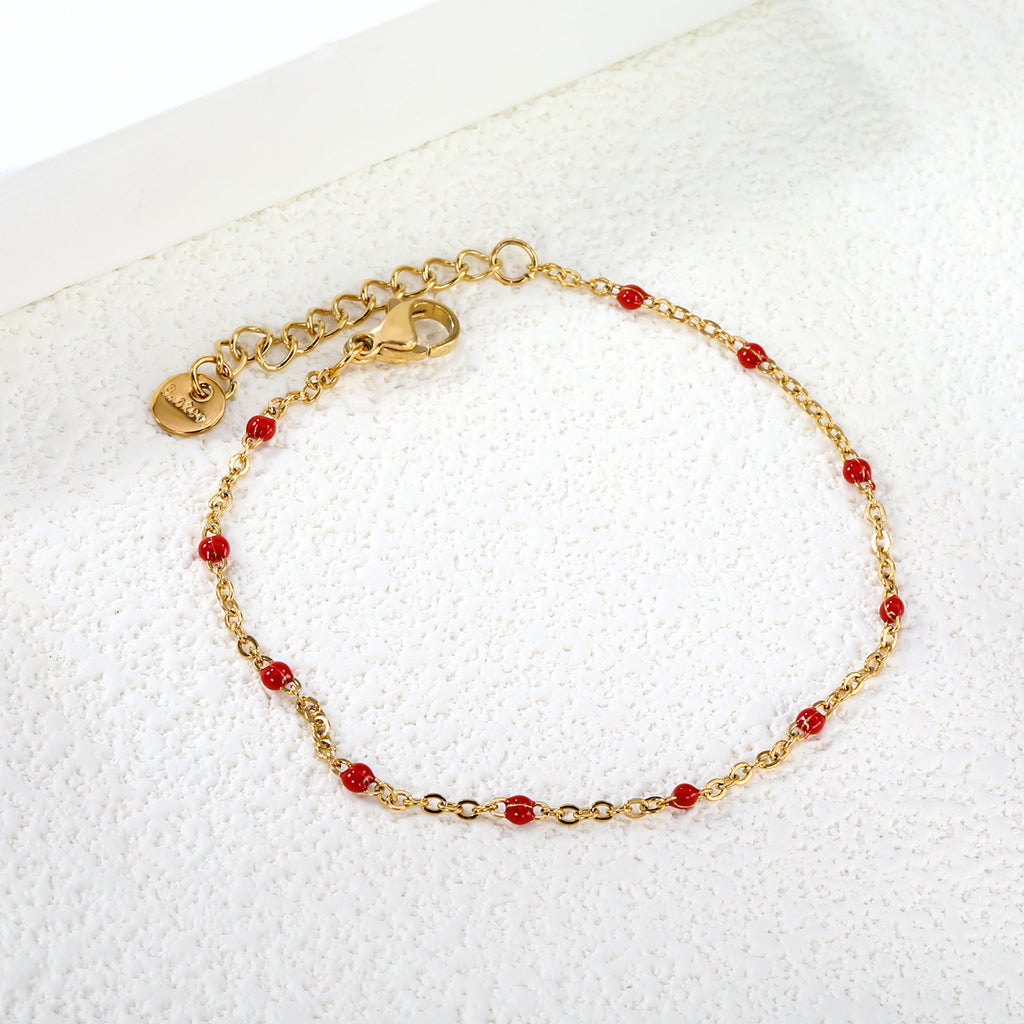 Damen zartes goldplattiertes Armband mit roten Akzenten Shop Nory