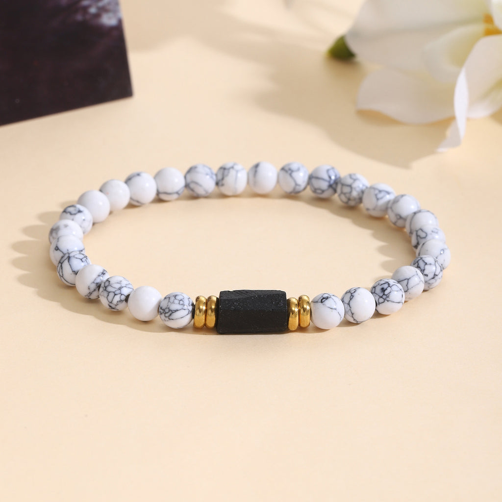 Damenarmband aus Rosenquarz mit schwarzem Akzent und goldenen Verzierungen Shop Nory