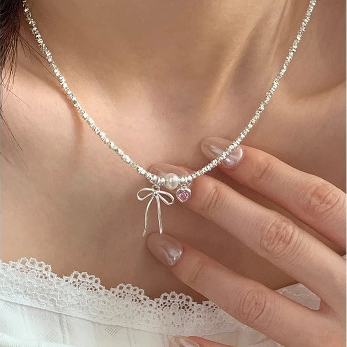Damen Armreif mit Herz-, Perlen- und Schleifenanhänger Shop Nory