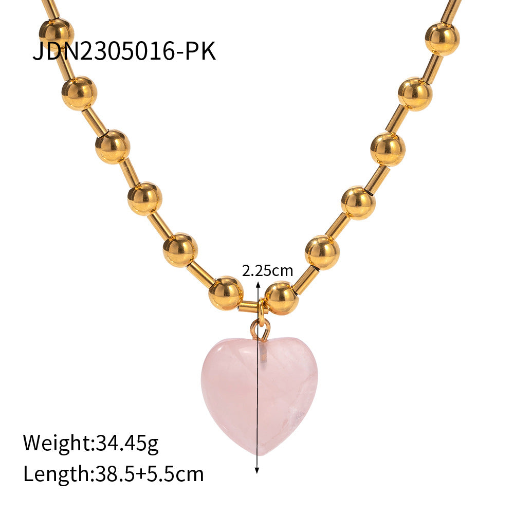 Damen Halskette mit transparentem Herzanhänger und goldene Kugel-Details Shop Nory
