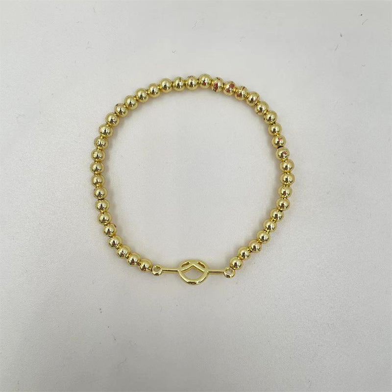 Damen Armband aus feinen, goldfarbenen Kugelperlen Shop Nory