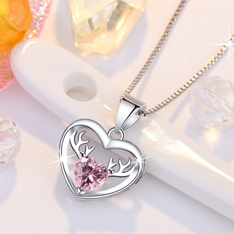 Damen Halskette mit herzförmigem Anhänger und eleganten Hirschakzenten Shop Nory