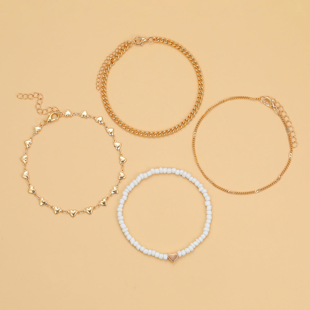 Damen Fußkettchen-Set mit eleganten goldenen und weißen Akzenten Shop Nory