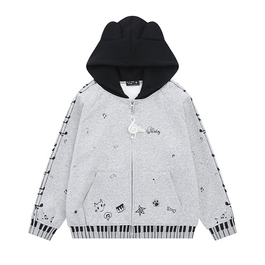 Damen Kapuzensweatjacke mit durchgehendem Reißverschluss, Musikprint, Klaviertasten‑Bündchen und Ohrenkapuze Shop Nory