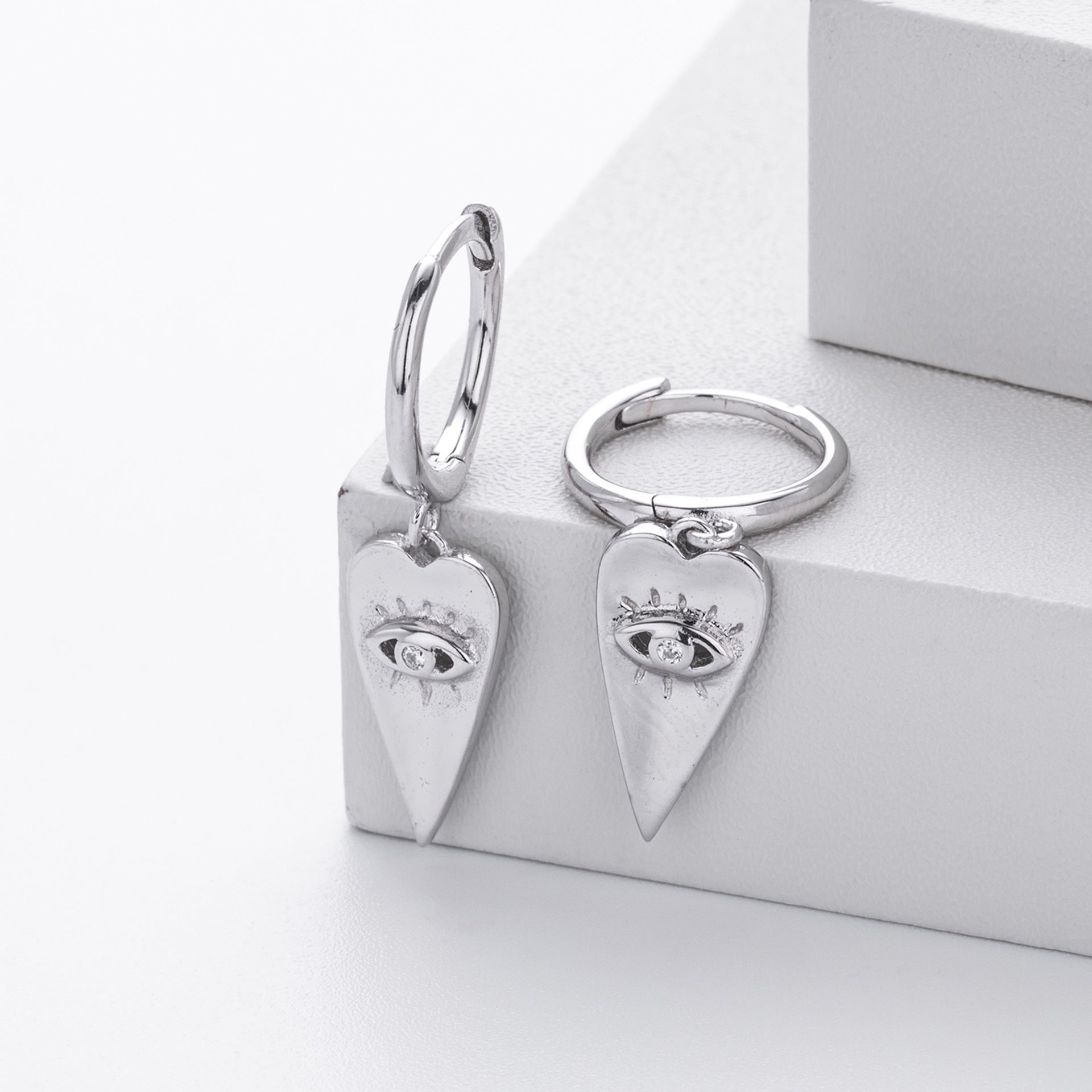 Damen Ohrringe mit herzförmigem Anhänger und schützendem Augenmotiv Shop Nory