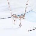 Damen Halskette mit filigranem Schleifenanhänger und funkelndem Zirkon Shop Nory