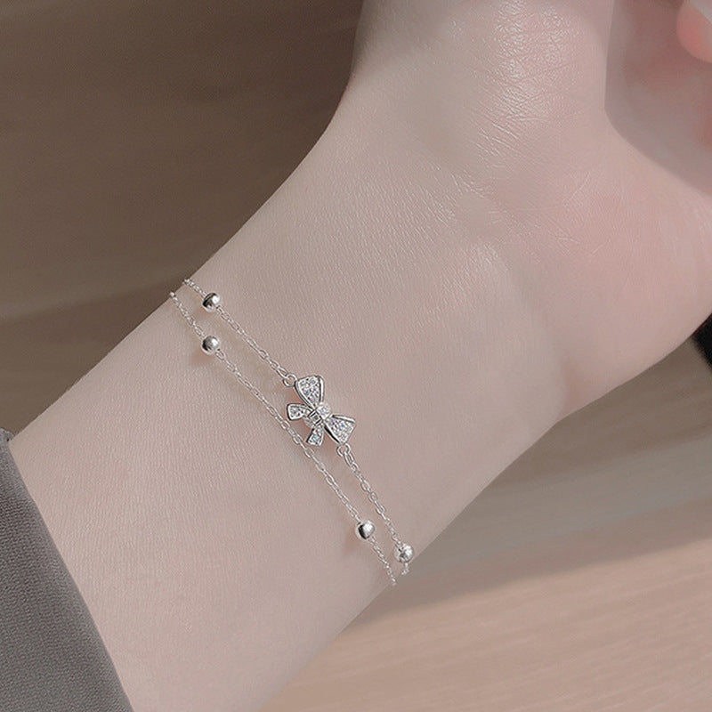 Damen Armband mit zartem Schleifen-Design und funkelnden Kristallen Shop Nory