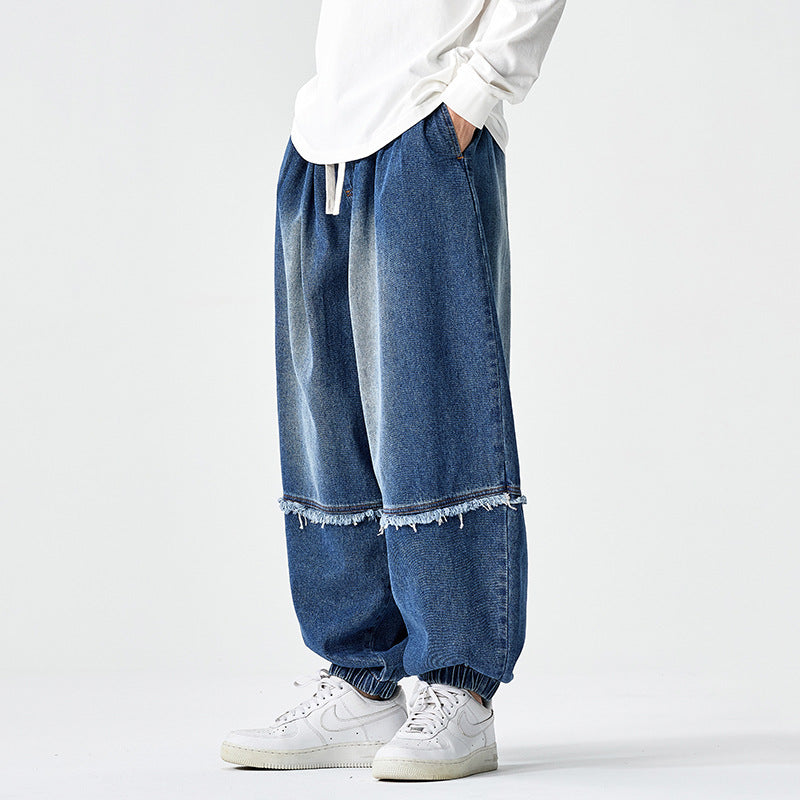 Herren Weit geschnittene Baggy-Denim-Hose mit Tunnelzug, elastischen Beinabschlüssen und Fransen-Detail Shop Nory