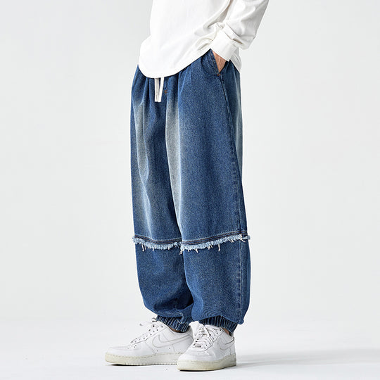 Herren Weit geschnittene Baggy-Denim-Hose mit Tunnelzug, elastischen Beinabschlüssen und Fransen-Detail Shop Nory