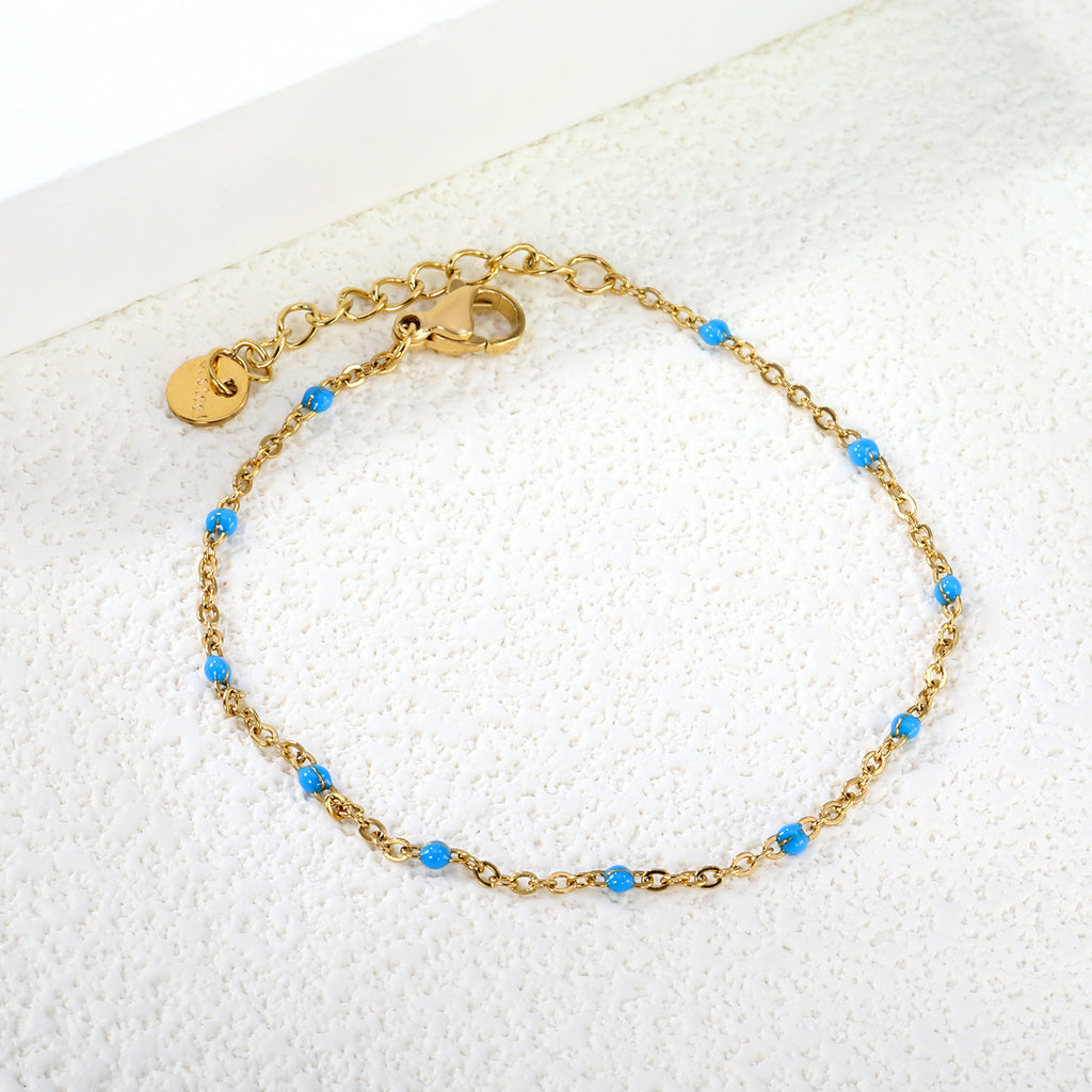 Damen zartes goldplattiertes Armband mit roten Akzenten Shop Nory