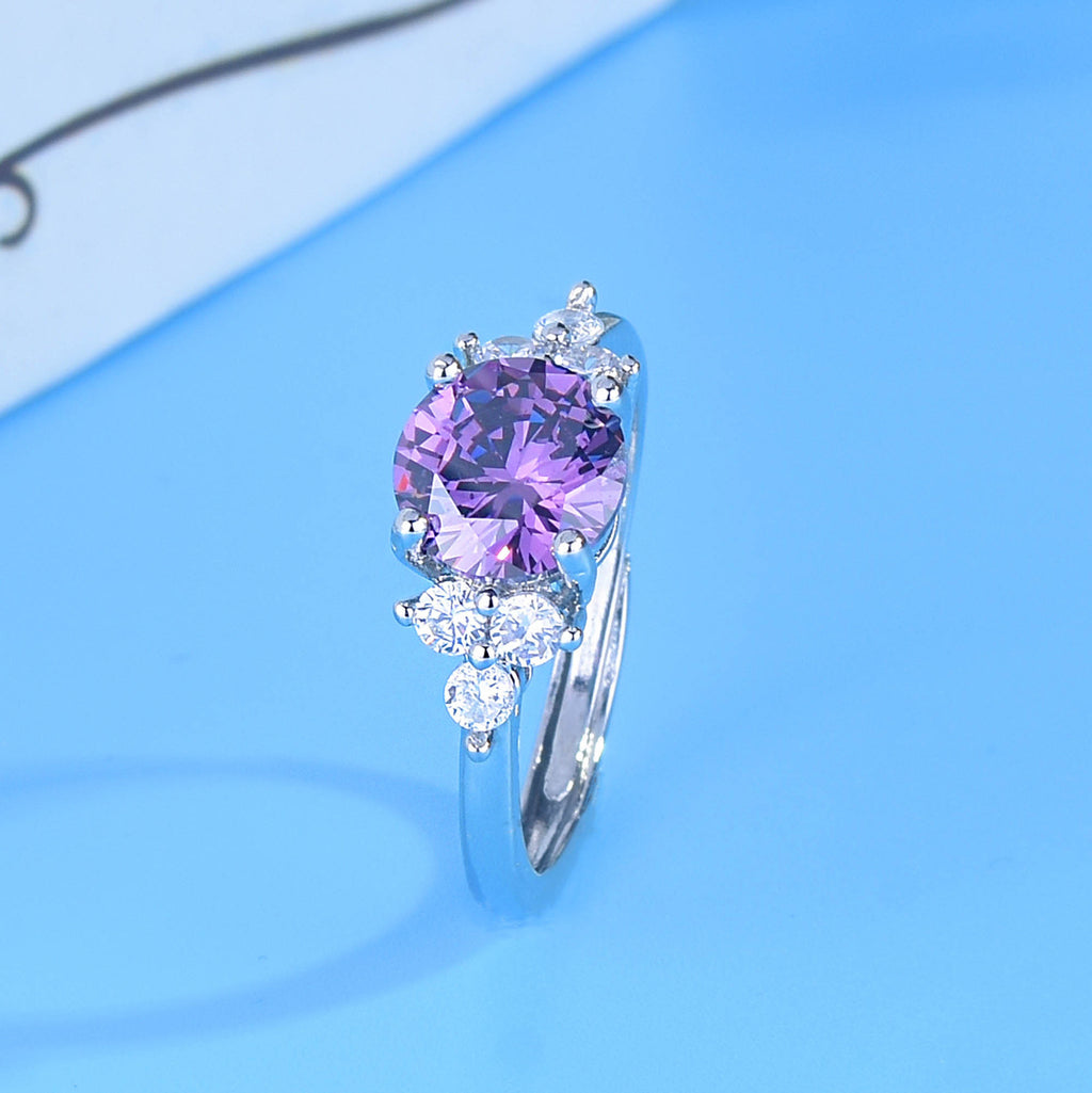 Damen eleganter Ring mit violettem Hauptstein und funkelnden Zirkonia Shop Nory
