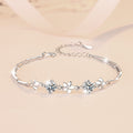 Damenarmband mit floralem Design und funkelnden Kristallen Shop Nory