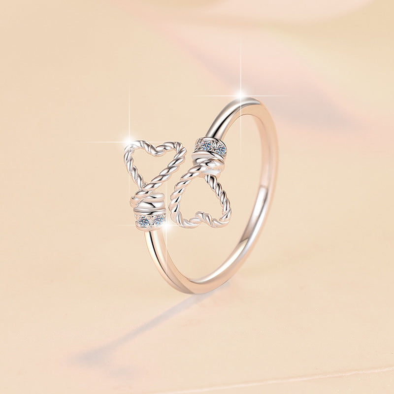 Damenring mit verschnörkeltem Herzdesign und glitzernden Zirkonia Shop Nory